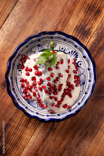 Chile en Nogada, Typical dish from Mexico. Prepared with poblano chili stuffed with meat and fruits and covered with a special walnut sauce. Named as the quintessential Mexican dish. photo