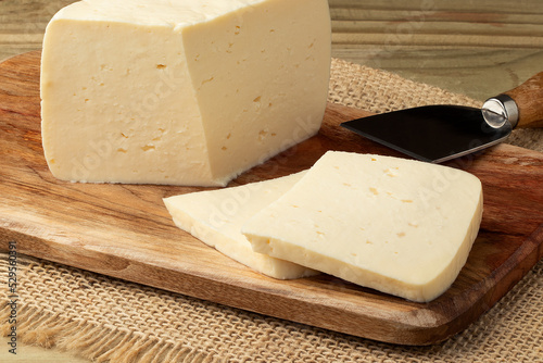 Brazilian fresh cheese on cutting board.