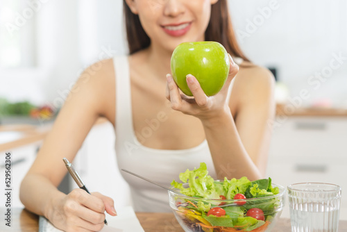 Diet, Dieting asian young woman, girl working diet plan right nutrition, hand holding green apple, vegetables salad is food for health not choose eat junk food. Nutritionist female, Weight loss person