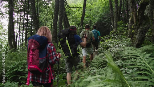 Teambuilding, rest with colleagues in mountains. Overcoming difficulties together in the wild