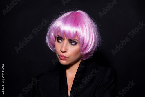 Beautiful hair coloring woman. Fashion Trendy haircut. Blond model with short pink wig.