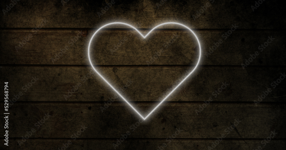 Image of glowing neon heart icon on brick wall Image of glowing neon heart icon on brick wall