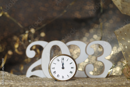 New Year concept, clock near to the midnight of 2023, golden bokeh background