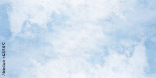 White clouds on painted puffy blue sky, winter seasonal blue sky background with blurry clouds, realistic morning sky surrounding with clouds cape.