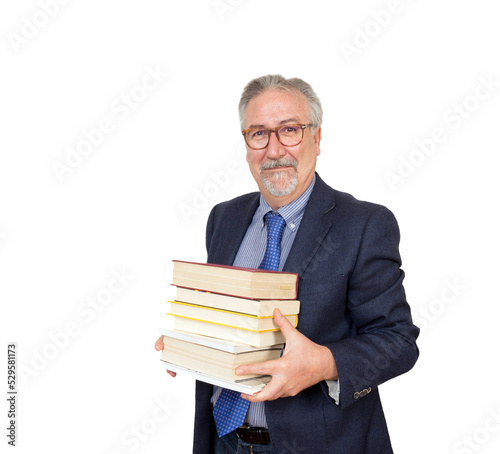 Senior teacher standing holding a book, with suit with necktie.