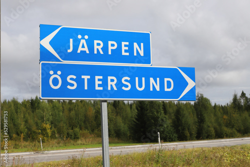 Sigpost with directional sign to the two Swedish towns Jarpen and Ostersund.