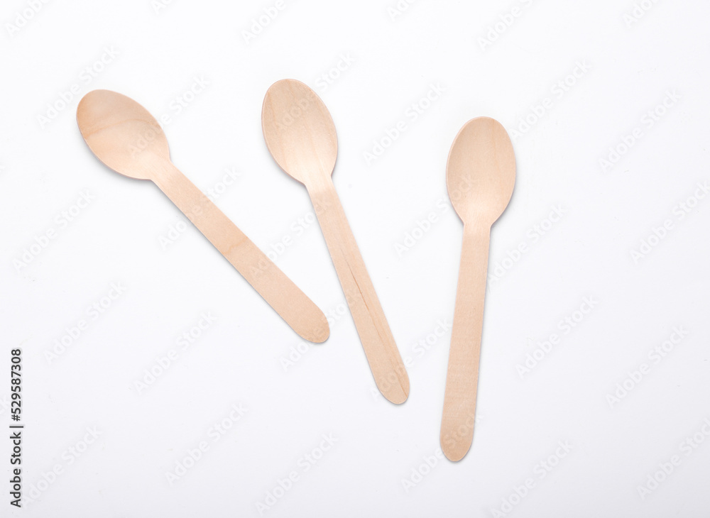 Three wooden spoons on a white background. Eco products Three wooden spoons on a white background. Eco products