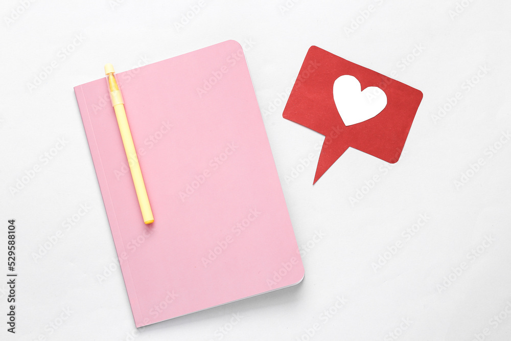 Notebook with like icon on gray background
