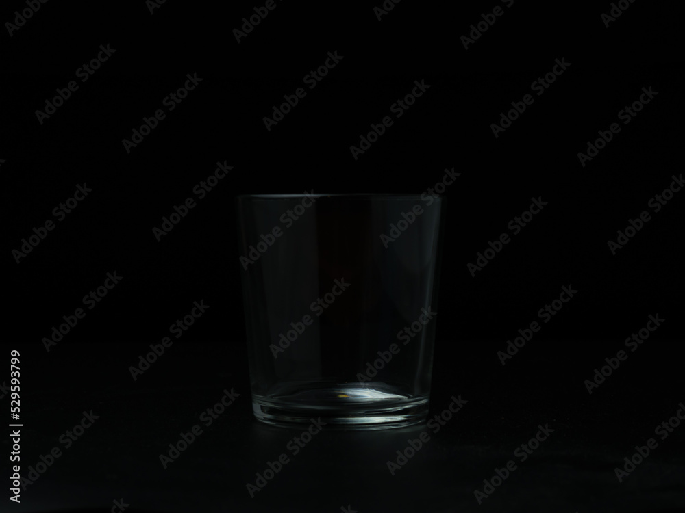 Empty glass on dark background.