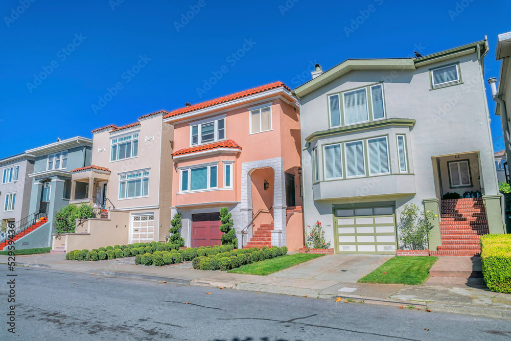 Three-storey houses exterior view against blue sky in San Francisco