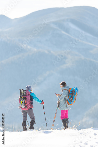 two girls travel in the mountains of winter.