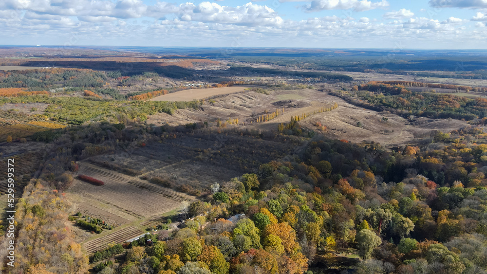 View from a height of the autumn forest and agricultural fields in the Kharkiv region 