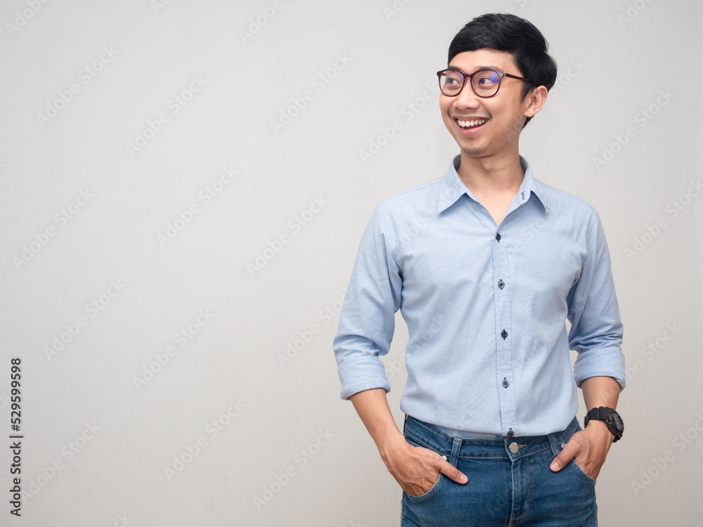 Positive man wear glasses happy smile looking at copy space Positive man wear glasses happy smile looking at copy space