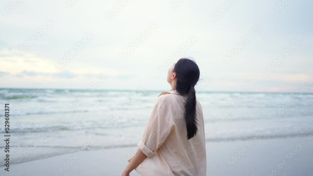 4K Young beautiful Asian woman travel on summer holiday vacation at tropical beach. Attractive girl relax and enjoy outdoor lifestyle walking on seaside beach with smiling at summer sunset. 4K Young beautiful Asian woman travel on summer holiday vacation at tropical beach. Attractive girl relax and enjoy outdoor lifestyle walking on seaside beach with smiling at summer sunset.