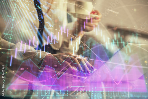 Double exposure of businesswoman hands typing on computer and financial graph hologram drawing. Stock market analysis concept.