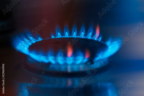 Gas burner on dark background. Natural gas flame. Blue flames from gas stove burner