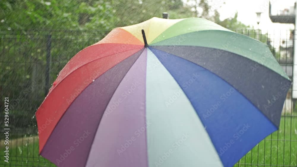 Rotating motley umbrella in the rain. Rotating motley umbrella in the rain.