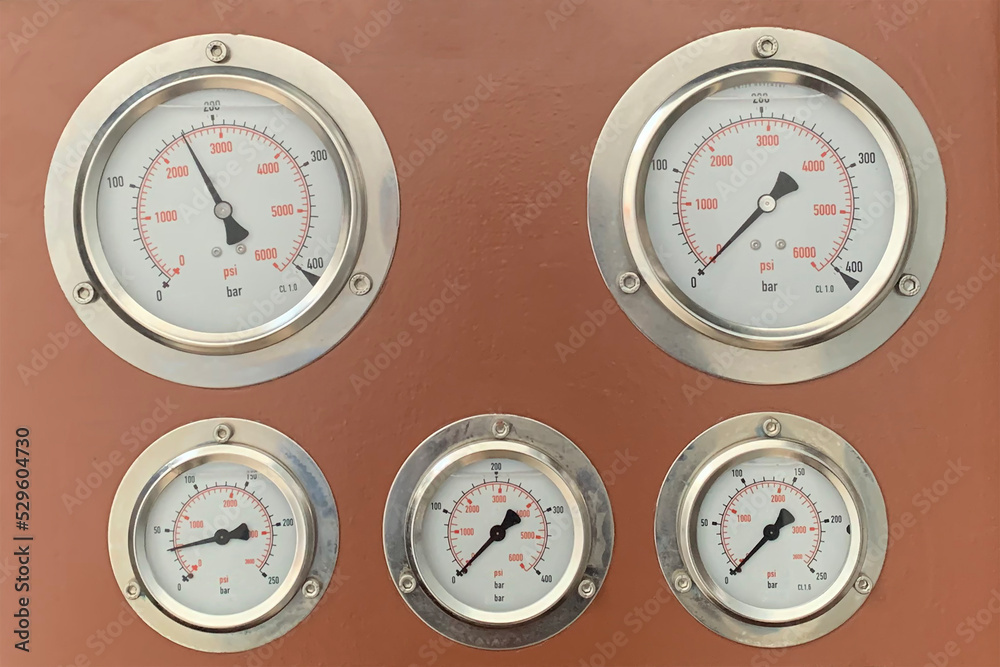 Hydraulic pressure gauge with on a control panel with other meters. Hydraulic pressure gauge with on a control panel with other meters.