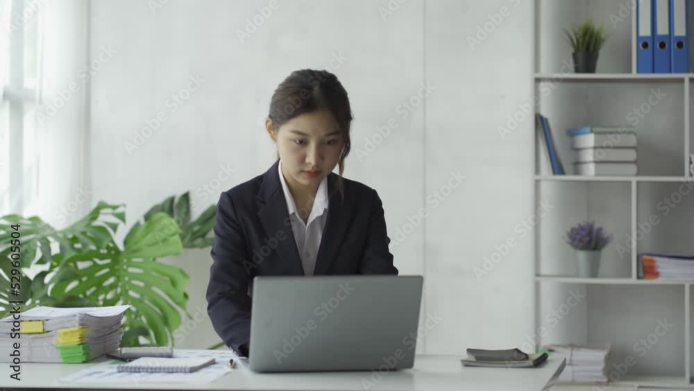 Close-up Asian businesswoman using calculator with tax calculator for chart and graph reports of home income and expense budget planner. Finance with online meetings with a laptop Close-up Asian businesswoman using calculator with tax calculator for chart and graph reports of home income and expense budget planner. Finance with online meetings with a laptop