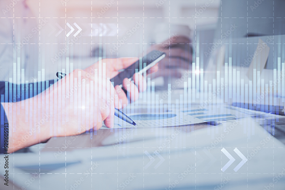 Double exposure of man's hands holding and using a phone and financial chart drawing. Market analysis concept. Double exposure of man's hands holding and using a phone and financial chart drawing. Market analysis concept.