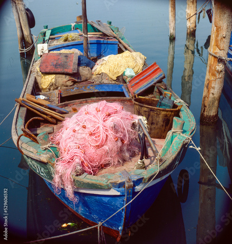 Pellestrina, Venezia. Barca da pesca ormeggiata, con reti e attrezzature varie photo