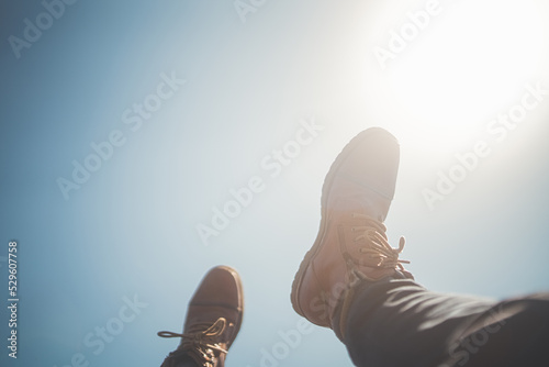 Hiking boots and brilliant sky photo