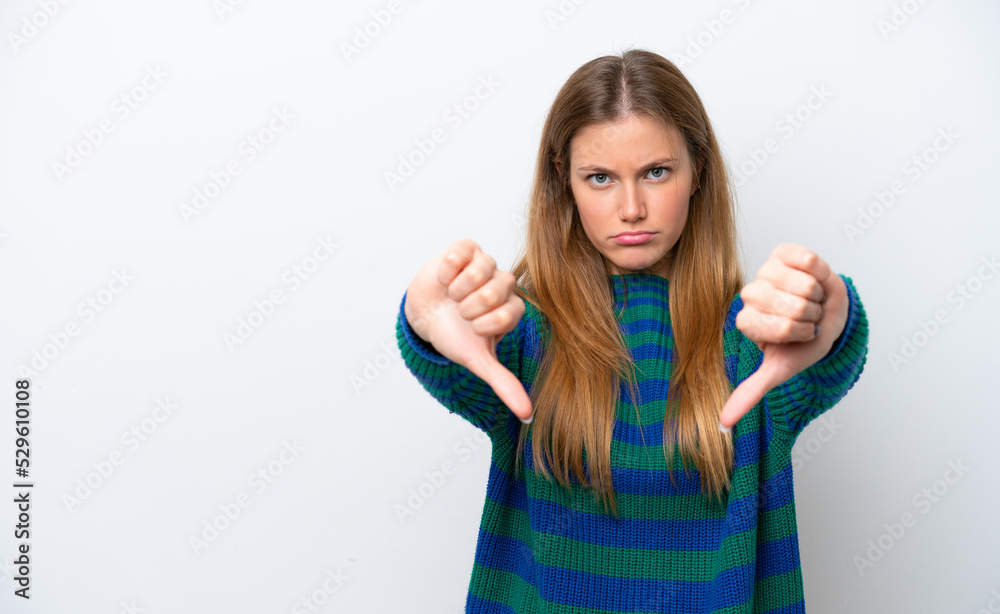Young caucasian woman isolated on white background showing thumb down with two hands Young caucasian woman isolated on white background showing thumb down with two hands