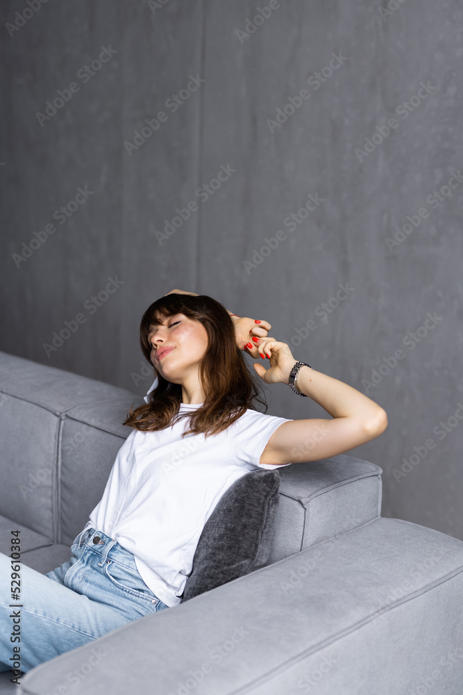 Young business woman working from home sitting on couch stretching arms happy and smiling Young business woman working from home sitting on couch stretching arms happy and smiling