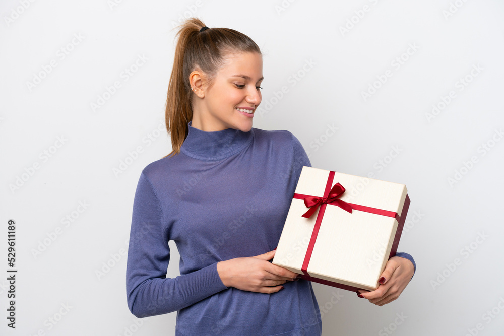 Young caucasian woman holding a gift isolated on white background with happy expression Young caucasian woman holding a gift isolated on white background with happy expression