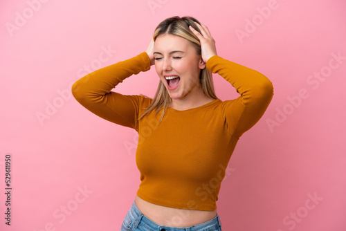 Young caucasian woman isolated on pink background stressed overwhelmed