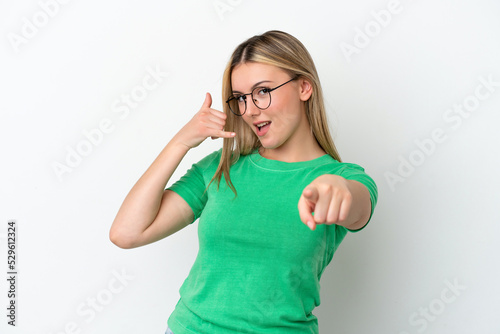 Young caucasian woman isolated on white background making phone gesture and pointing front