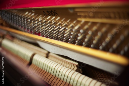 Inside an upright piano, strings and hammers closeup