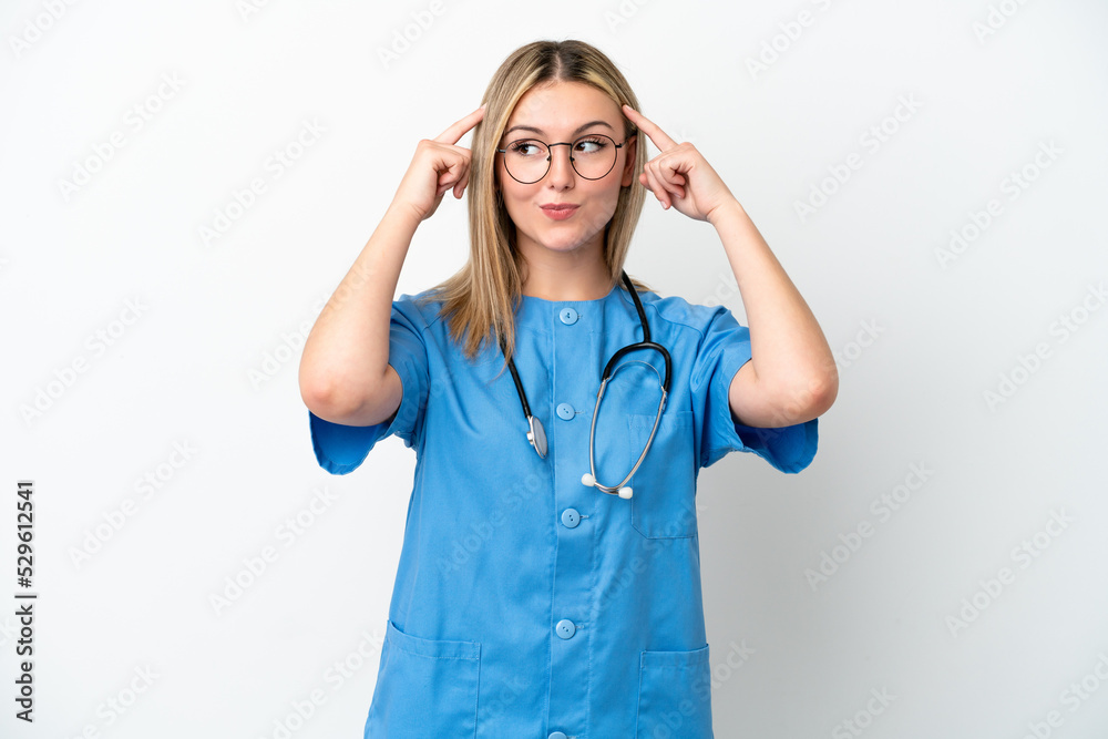 Young surgeon doctor woman isolated on white background having doubts and thinking Young surgeon doctor woman isolated on white background having doubts and thinking
