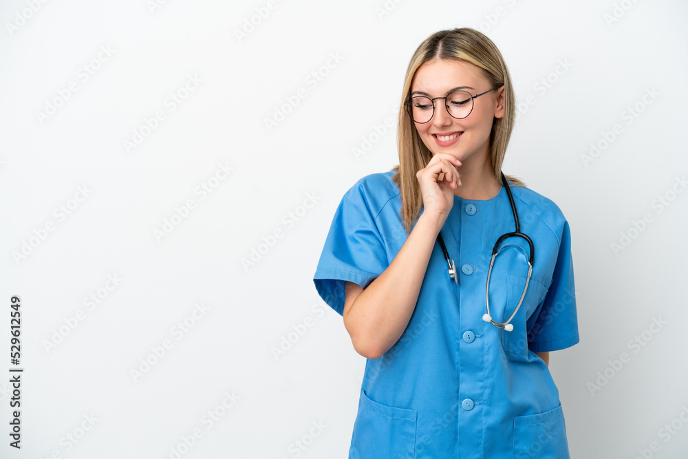 Young surgeon doctor woman isolated on white background looking to the side and smiling Young surgeon doctor woman isolated on white background looking to the side and smiling
