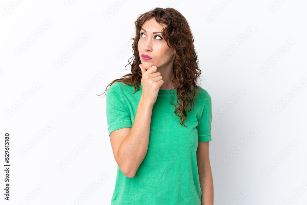 Young woman with curly hair isolated on white background having doubts Young woman with curly hair isolated on white background having doubts