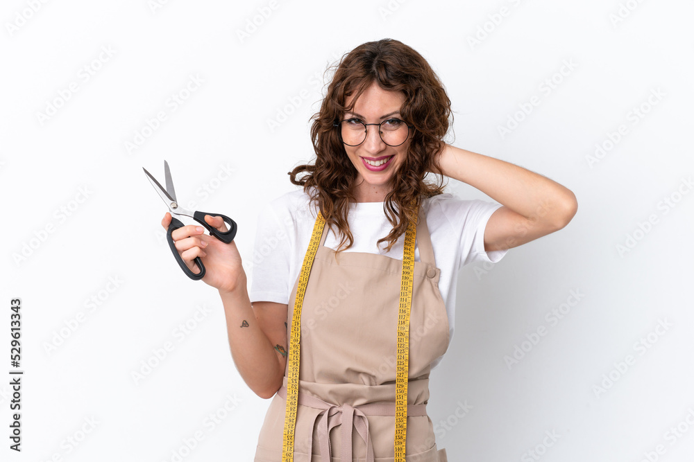 Young caucasian seamstress woman isolated on white background laughing Young caucasian seamstress woman isolated on white background laughing