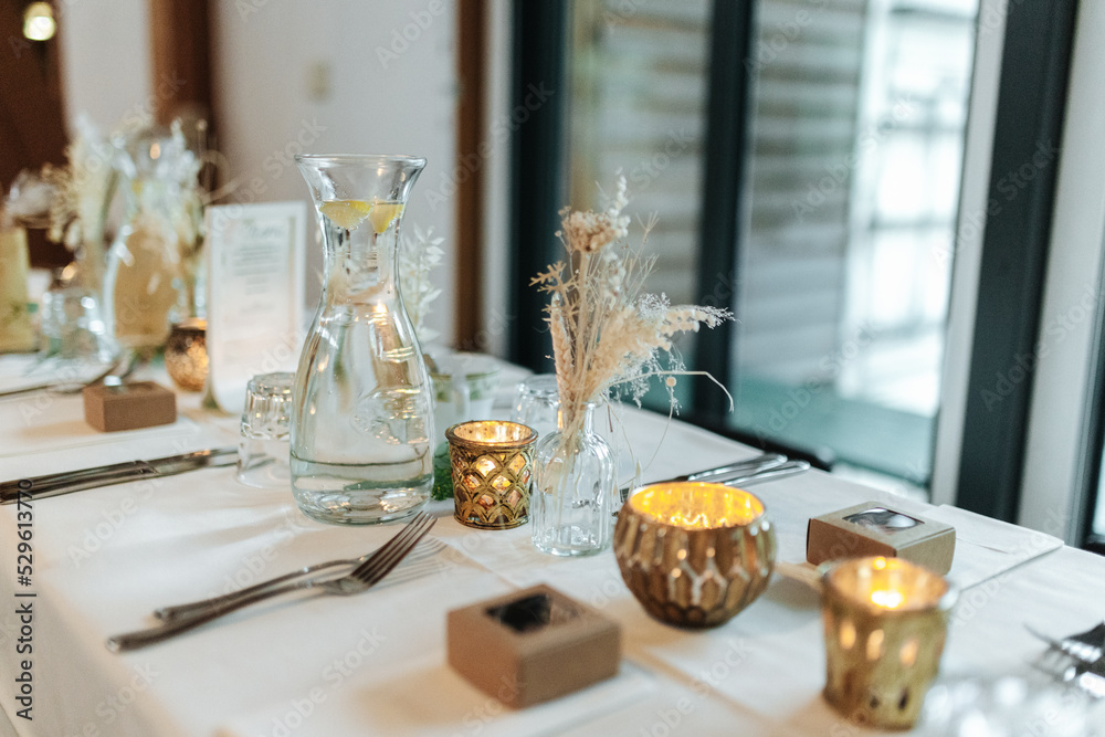 Elegant table setting and decoration for a dinner at a wedding location Elegant table setting and decoration for a dinner at a wedding location