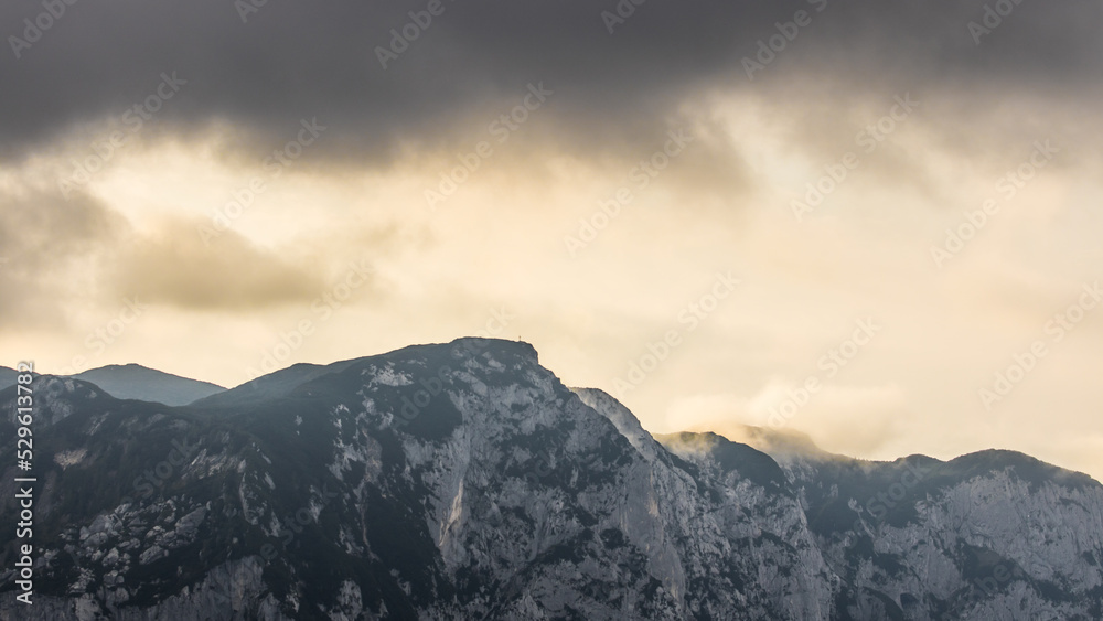 Cloudy weather condition with fog, clouds and a bit of sun in the Salzkammergut mountains in Austria