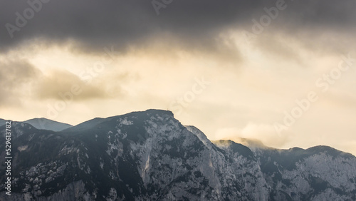 Cloudy weather condition with fog, clouds and a bit of sun in the Salzkammergut mountains in Austria
