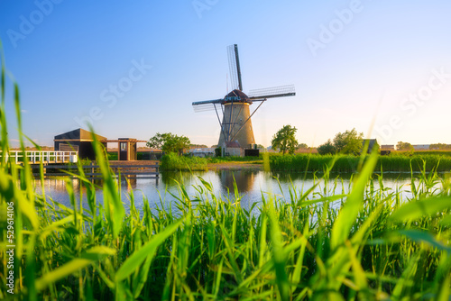 Kinderdijk National Park in the Netherlands. Windmills at the day time. A natural landscape in a historic location. Reflections on the water surface. Dutch canals. UNESCO World Heritage Site. photo