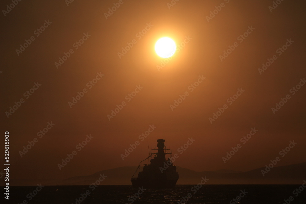 sunset and silhouette ship