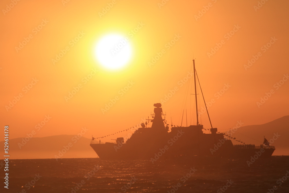 sunset and silhouette army ship