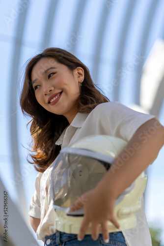 asian woman smiling with her astronaut helmet photo
