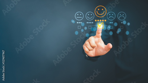 Man touching the virtual screen on the happy smiley face icon to give satisfaction in service. Rating very impressed. Customer service,  testimonial satisfaction concept.