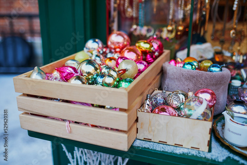 Many Christmas balls in wooden crate on Christmas market © Ekaterina Pokrovsky