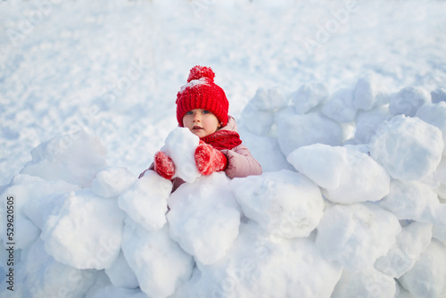 Adorable preschooler girl having fun in beautiful winter park on a snowy cold winter day © Ekaterina Pokrovsky