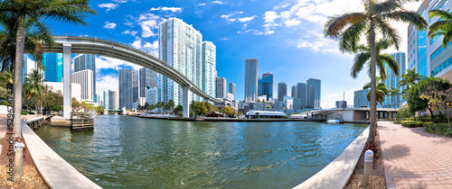 Miami downtown skyline and futuristic mover train above Miami river panoramic view photo