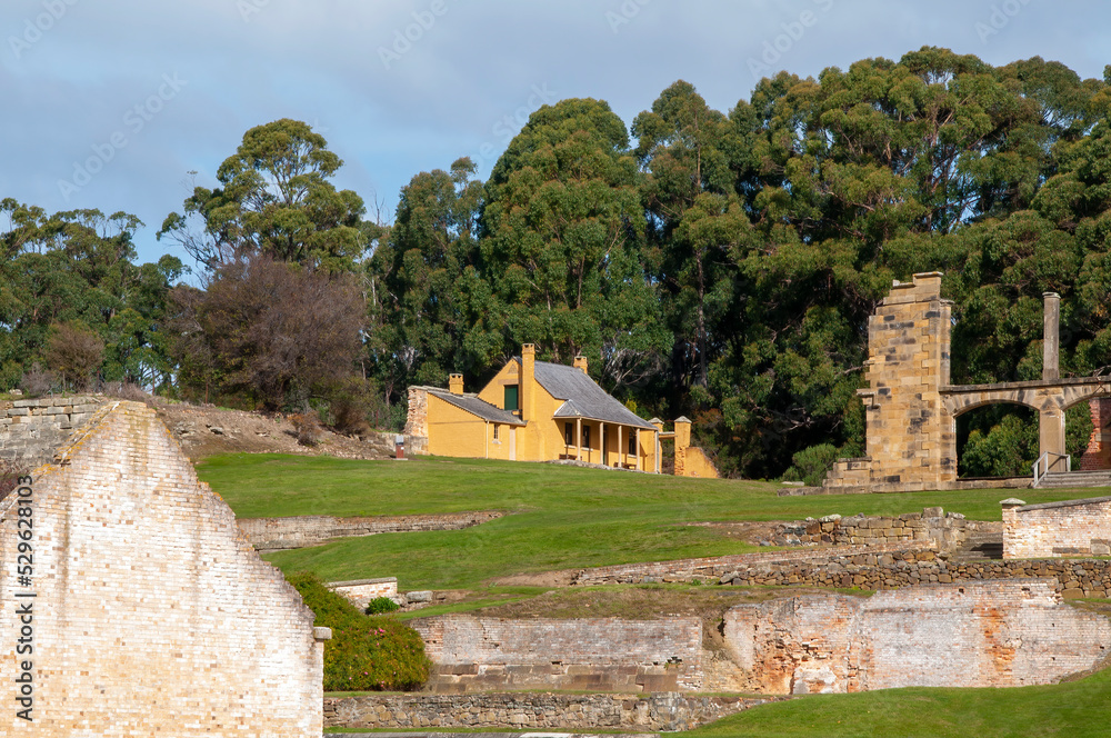 Port Arthur Australia, cottage on hill with convict settlement ruins in foreground
