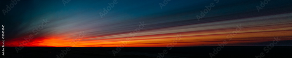 Obraz premium red sunset in dark clouds