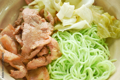 Korean fried slice pork with cabbage topping Chinese jade noodles dipping sukiyaki sauce on bowl